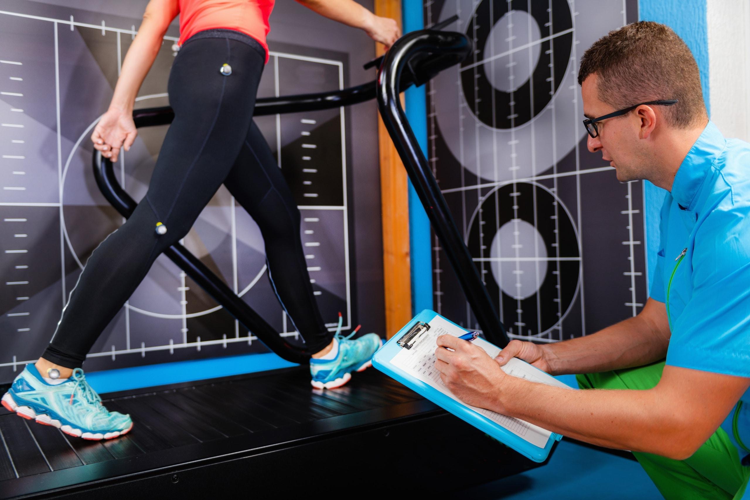 Male professional studying a patient's gait analysis in physical therapy